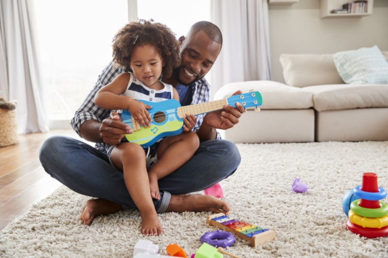 Air Conditioners: Things You May Not Have Known. Dad and toddler playing guitar.