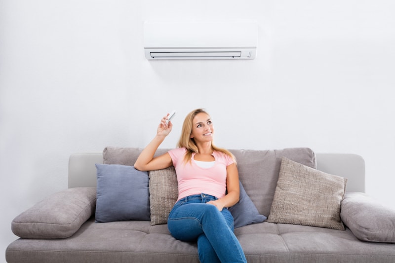 Woman enjoying better indoor air quality in her Flagstaff, AZ, living room. Campbell's A/C LLC blog image.