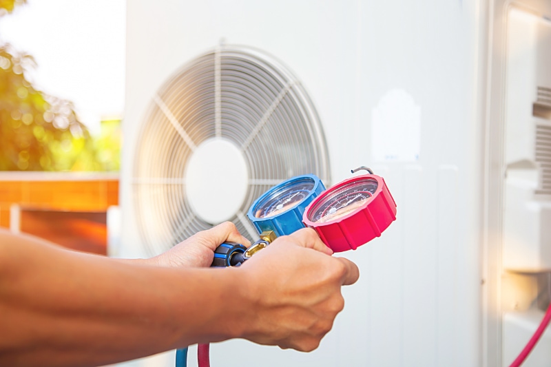 Technician performing a maintenance inspection on a heat pump in Williams, AZ. Campbell's A/C LLC blog image.